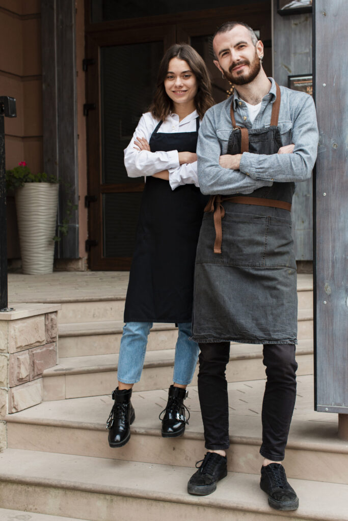 business partners posing with apron scaled 1